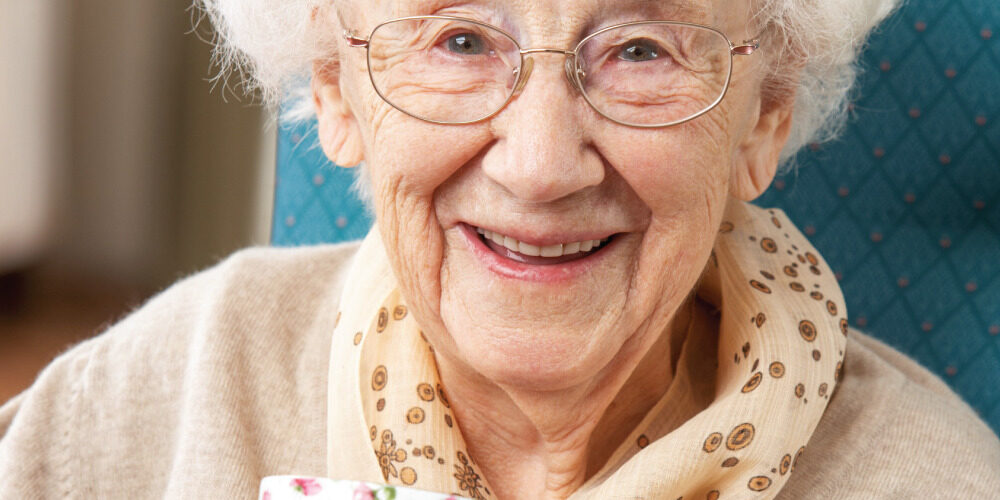 Happy-Senior-Woman-Enjoying-a-Cup-of-Tea Happy Senior Woman drinking a cup of tea
